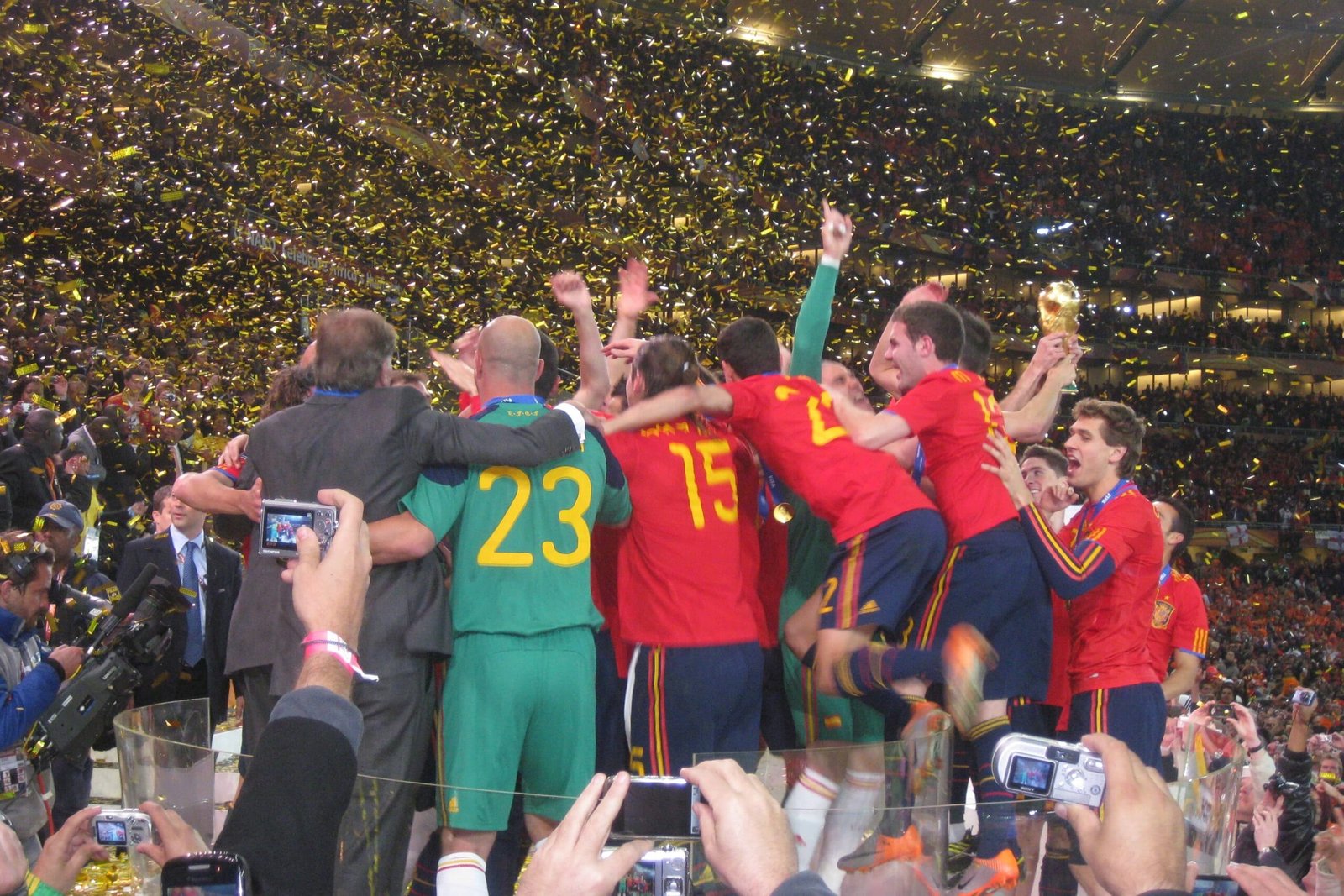 Spain national team celebrating after winning the 2010 FIFA World Cup final against Netherlands in South Africa with trophy lift.