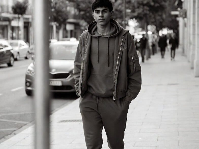 Lamine Yamal walking casually on a city street.