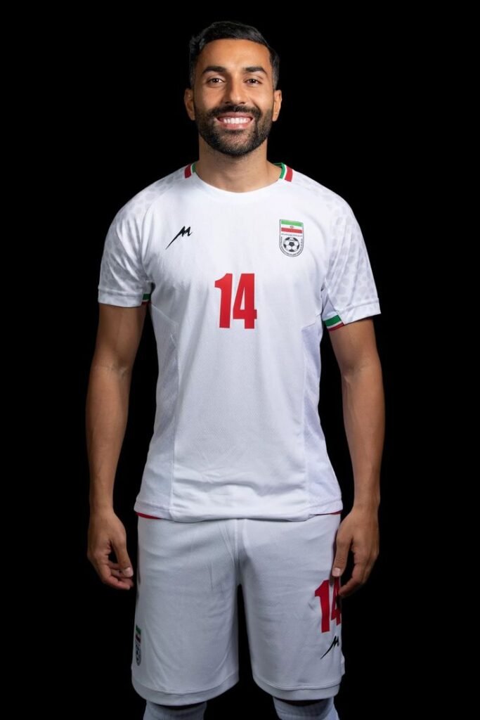 Saman Ghoddos controlling the ball during an Iran national team match.